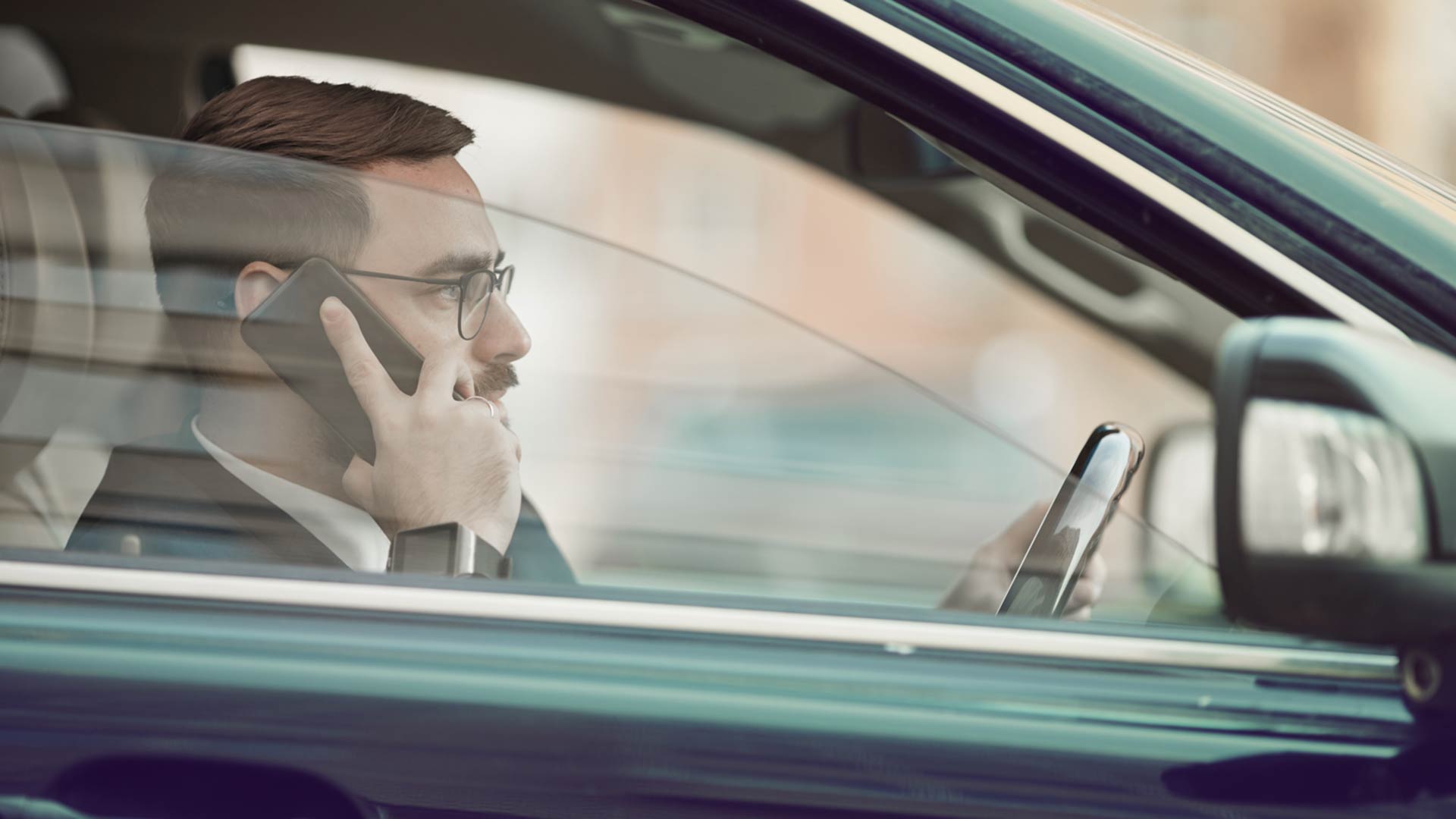 Man using a mobile phone while driving